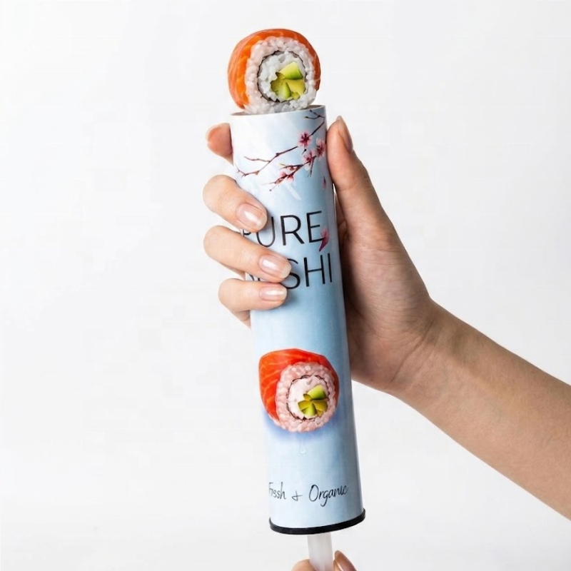 Hand pushing up a sushi roll from a Ganfaner push pop sushi tube - eat sushi on the go without chopsticks