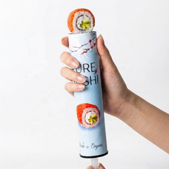 Hand pushing up a sushi roll from a Ganfaner push pop sushi tube - eat sushi on the go without chopsticks